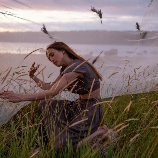 Person meditating in a calm, balanced environment.